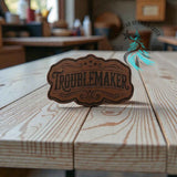All-American Troublemaker leather hat patch shown at an angle