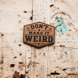 Close-up of the engraved Don't Make it Weird leather hat patch