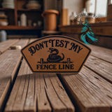 Close-up of the Don't Test My Fence Line leather hat patch