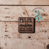 Get in Loser, We're Going Hunting leather hat patch shown at an angle