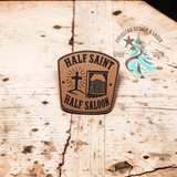 Close-up of the engraved Half Saint Half Saloon leather hat patch