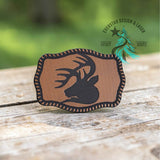 Leather hat patch with a buck silhouette on a linen textured background