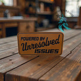 Close-up of the Powered by Unresolved Issues leather hat patch