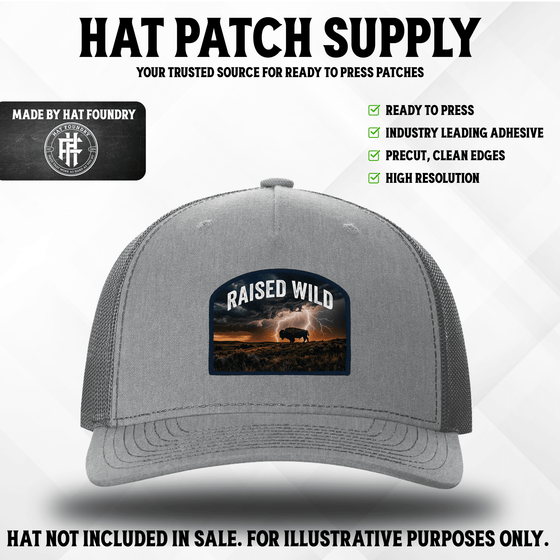 UV printed hat patch reading Raised Wild with an outdoor wilderness design