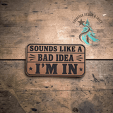 Close-up of the engraved Sounds Like a Bad Idea leather hat patch