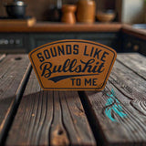 Close-up of the engraved Sounds Like Bullshit leather hat patch